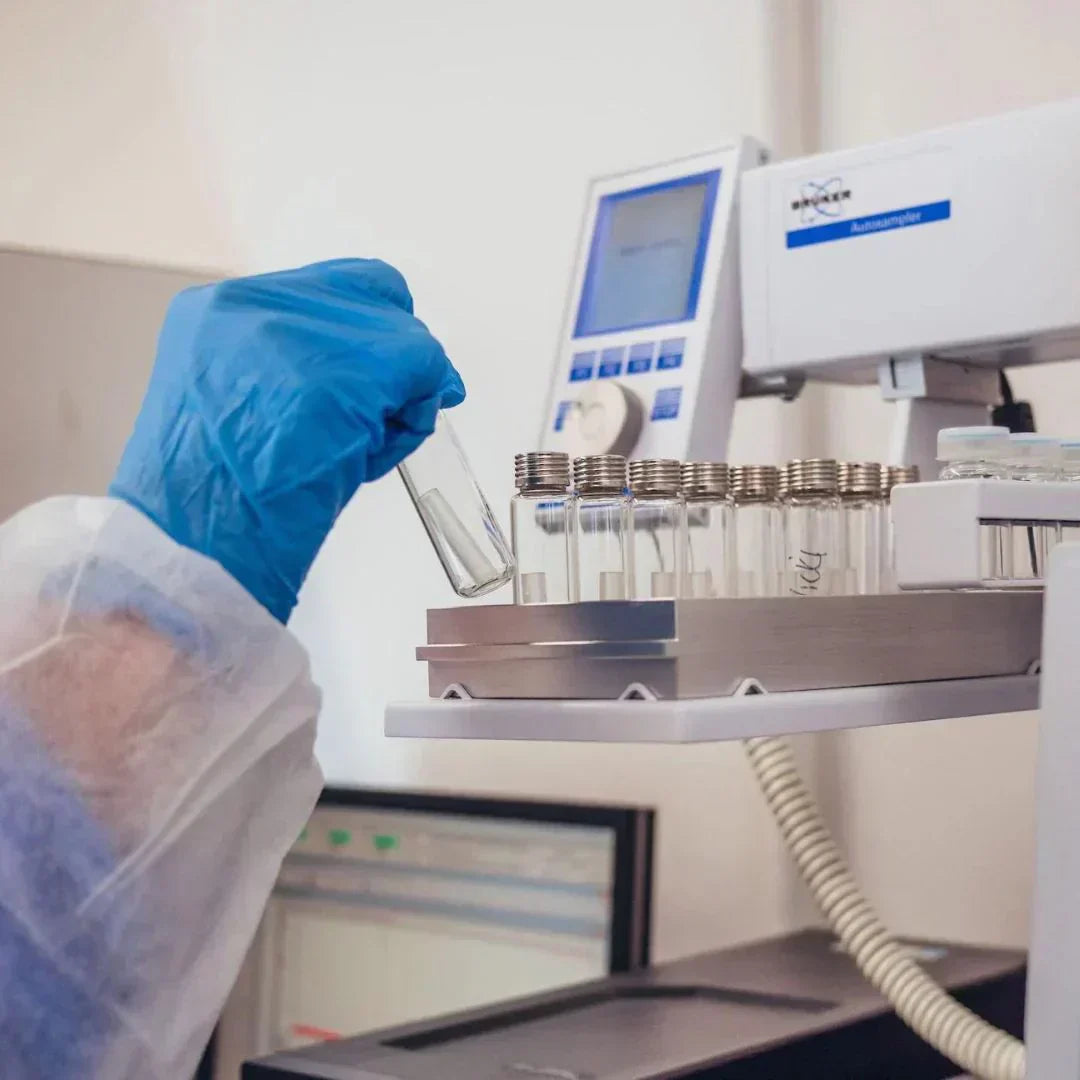 Person in lab grabbing capsules