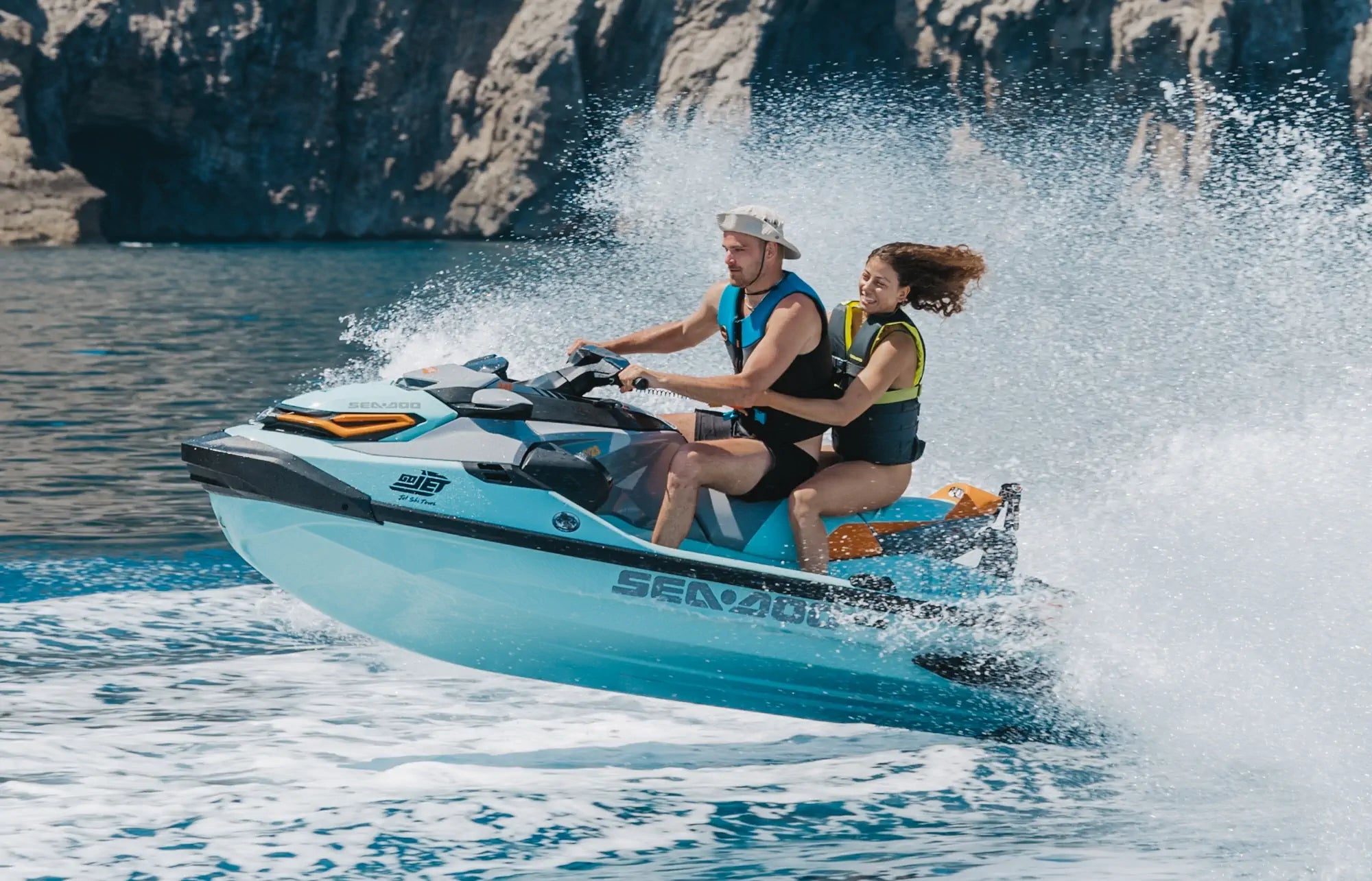 Man and Woman splashing on a jet ski