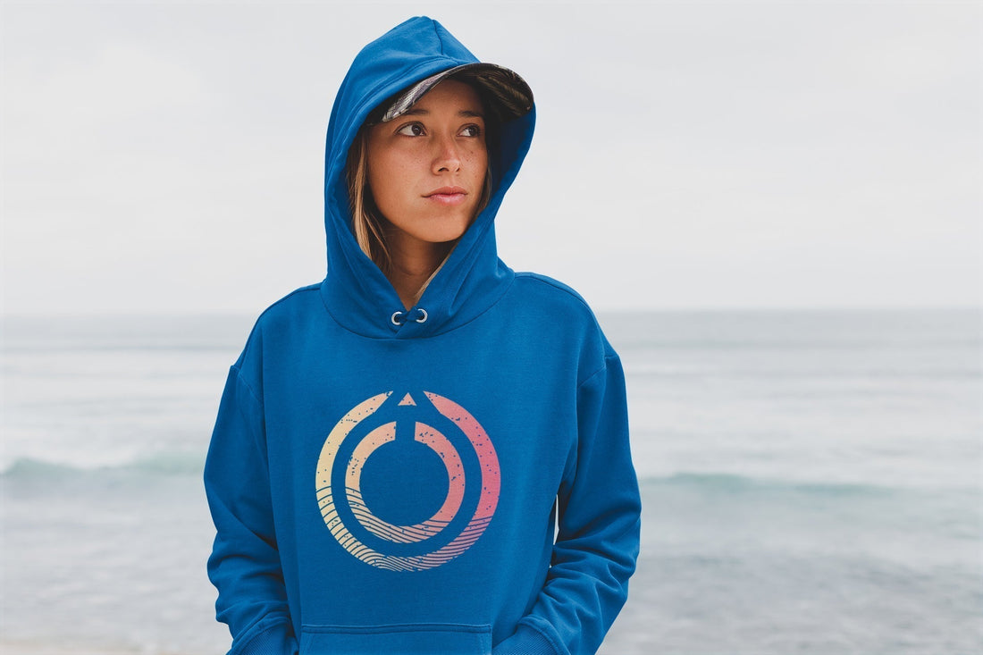 A young woman with a hoodie at the beach