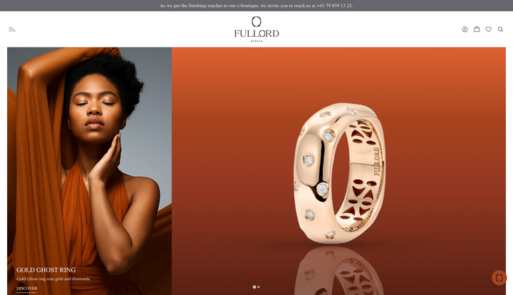 Gold ring with intricate design on a brown background, next to a model wearing an orange dress.
